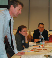 Kevin Jones leaning over a desk in a classroom